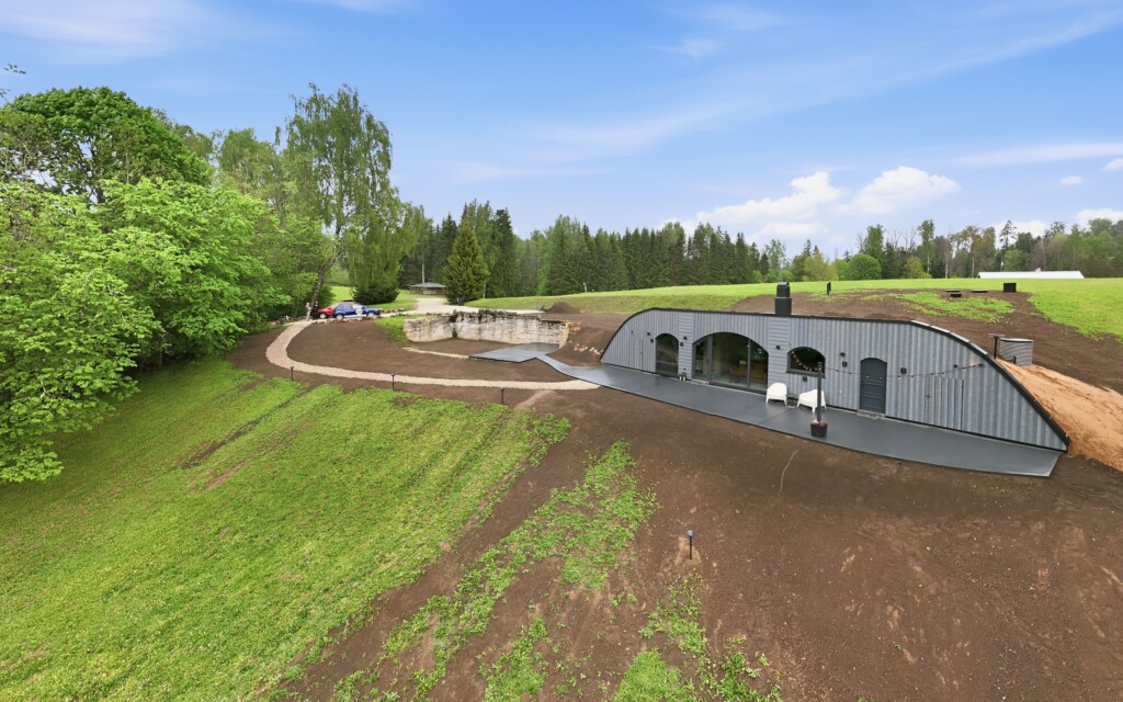 Revonia underground vault house under construction – aerial view of arched prefab modules being installed at Riverberg estate, Otepää